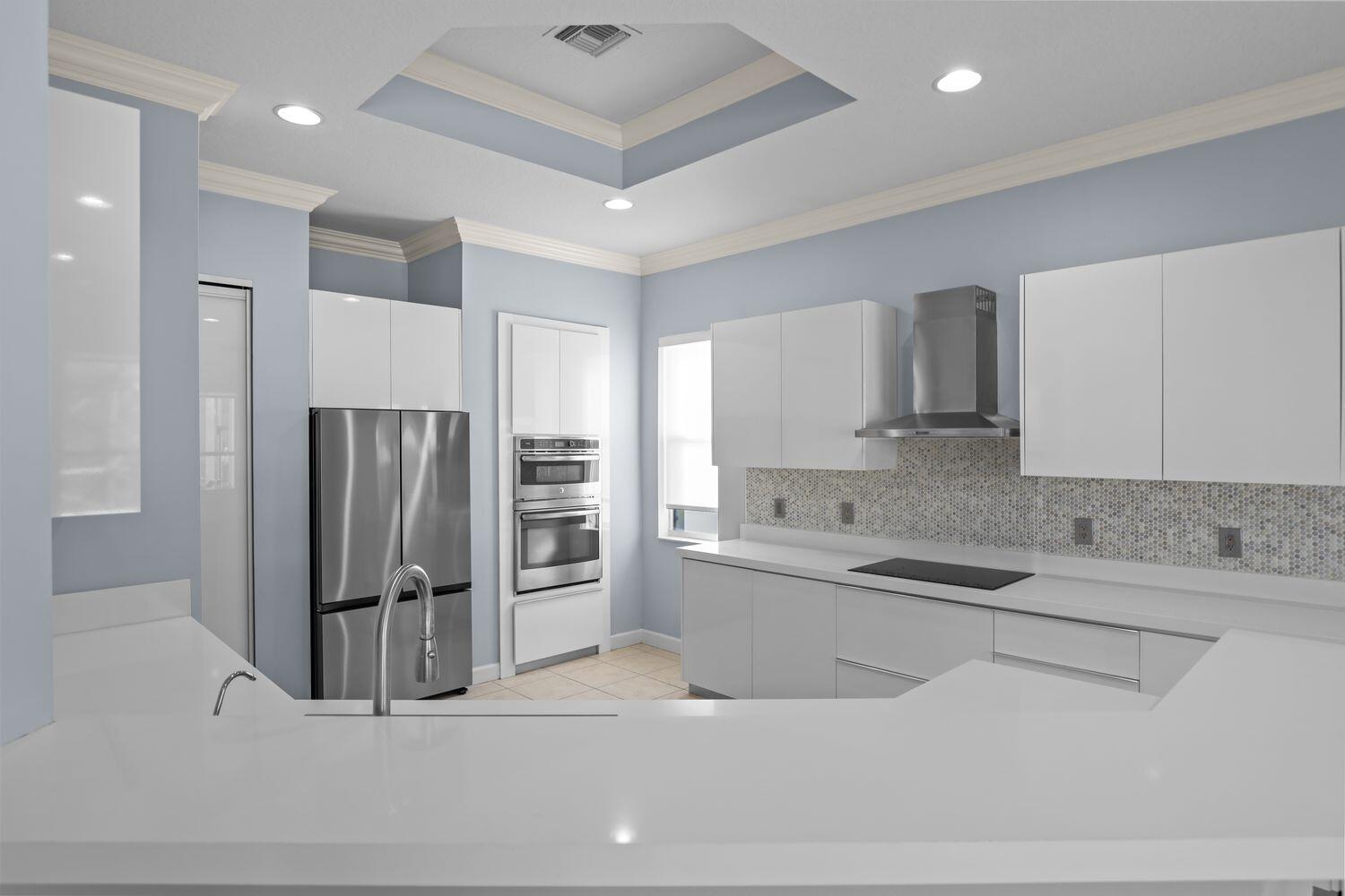 9152 Short Chip Circle Port St. Lucie, FL 34986 - Photo 18 of 72 a kitchen with stainless steel appliances granite countertop a refrigerator and a sink