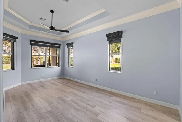 a view of a porch with a floor to ceiling window and wooden fence