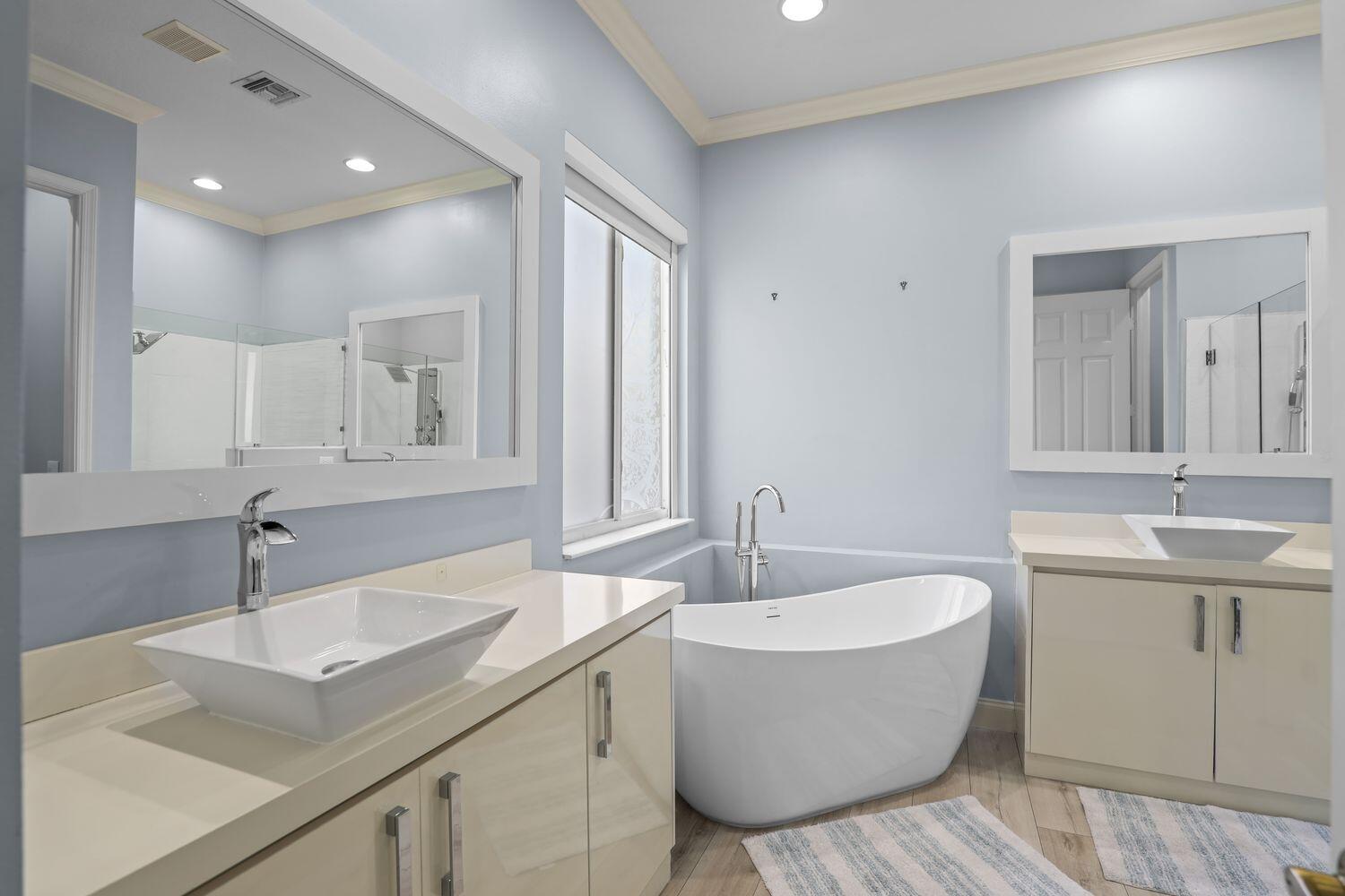 9152 Short Chip Circle Port St. Lucie, FL 34986 - Photo 25 of 72 a bathroom with a double vanity sink and a bathtub