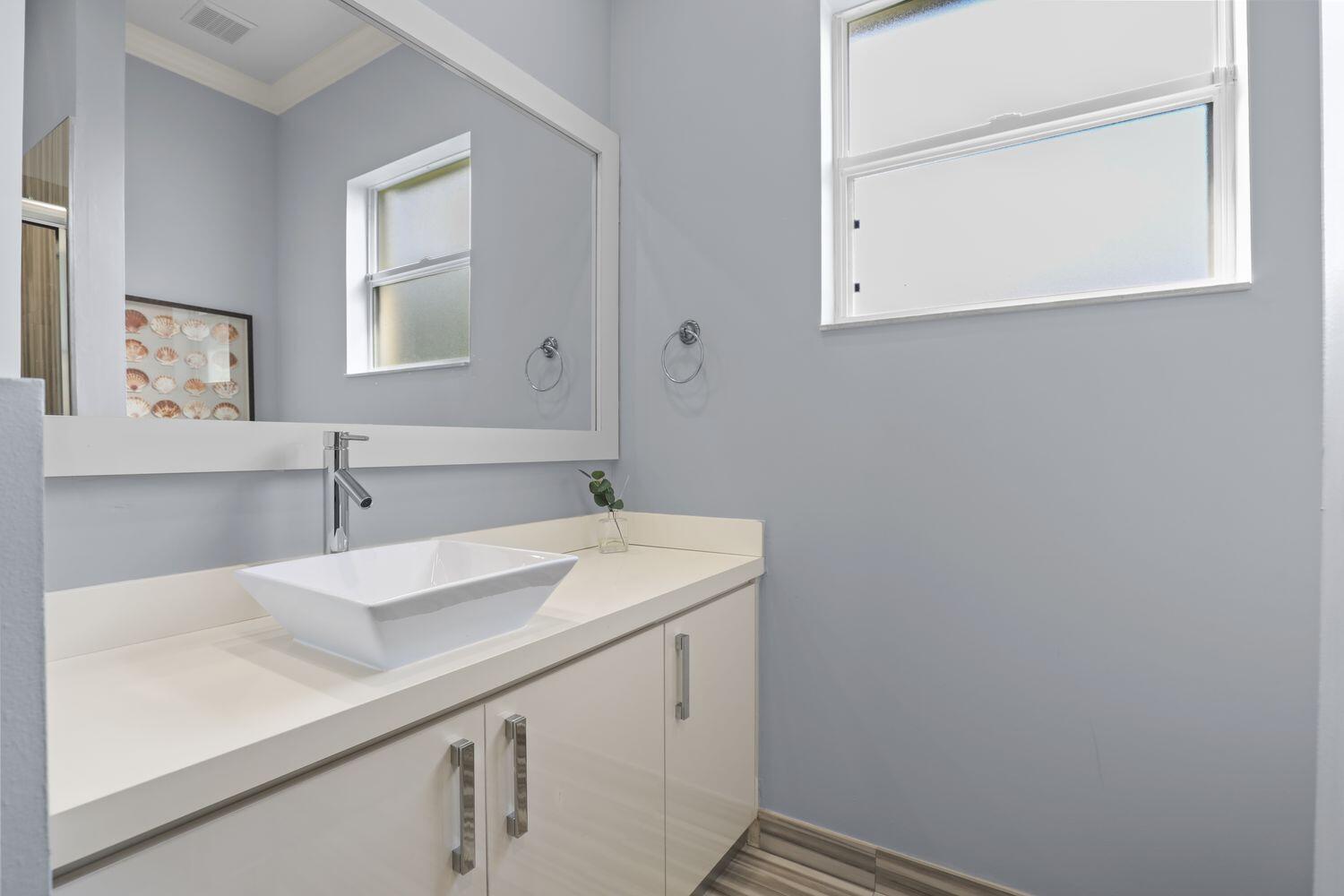 9152 Short Chip Circle Port St. Lucie, FL 34986 - Photo 26 of 72 a bathroom with a sink vanity and a mirror