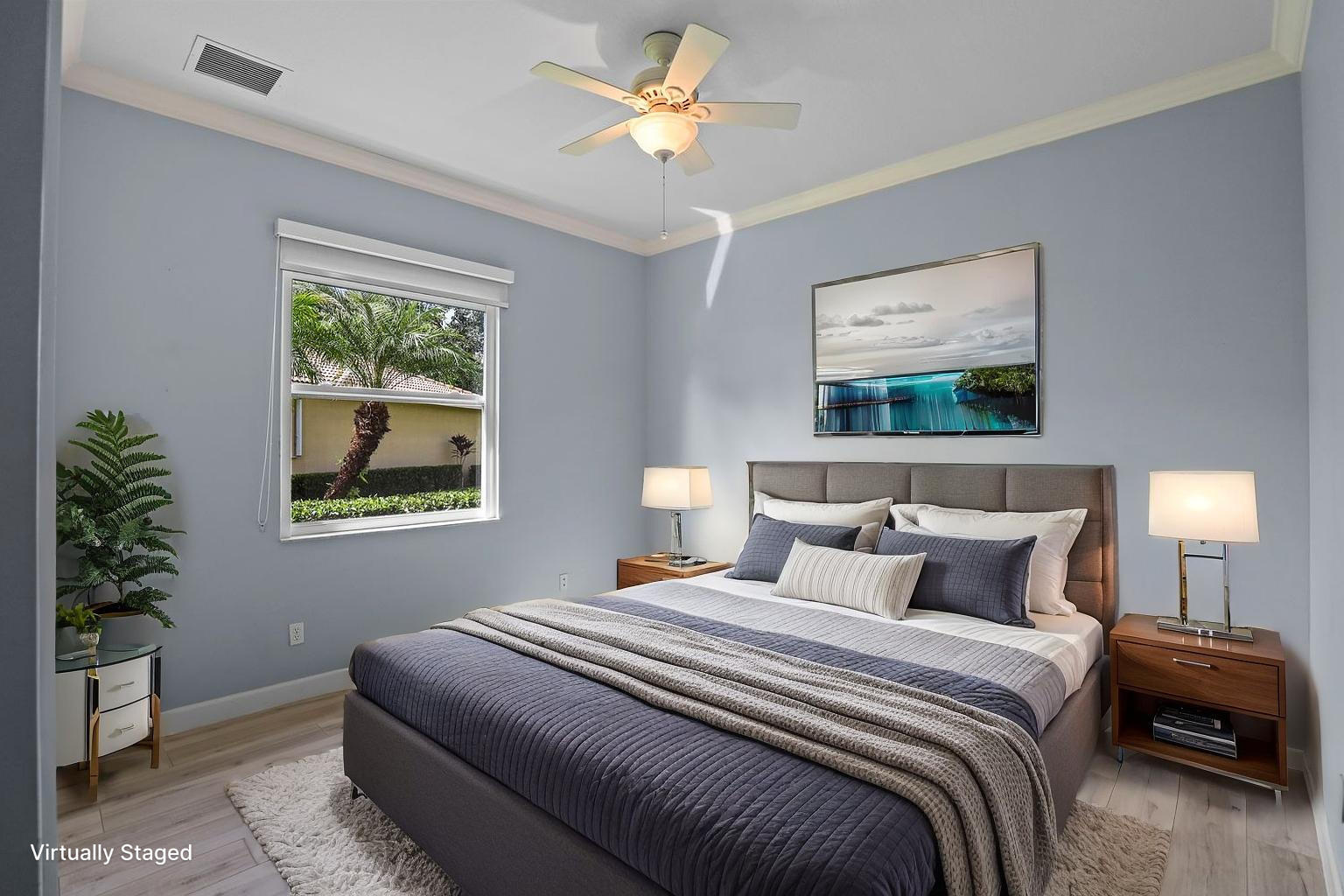 9152 Short Chip Circle Port St. Lucie, FL 34986 - Photo 27 of 72 a bedroom with a bed and a painting on the wall