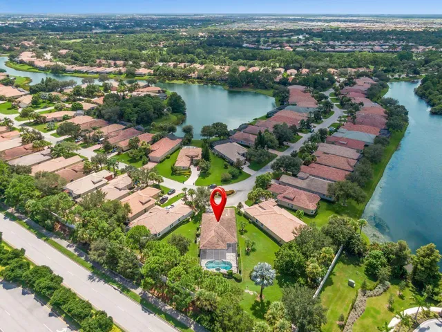 an aerial view of residential houses with outdoor space and river