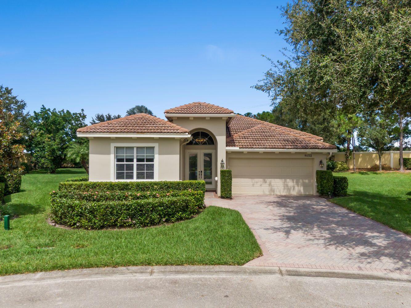 9152 Short Chip Circle Port St. Lucie, FL 34986 - Photo 41 of 72 a front view of a house with a yard