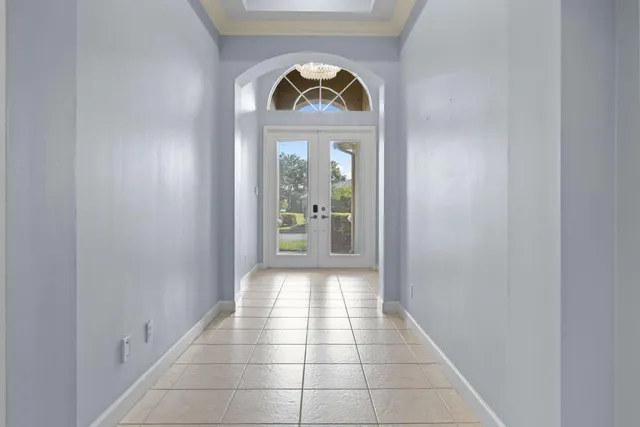 a living room with furniture and a view of kitchen