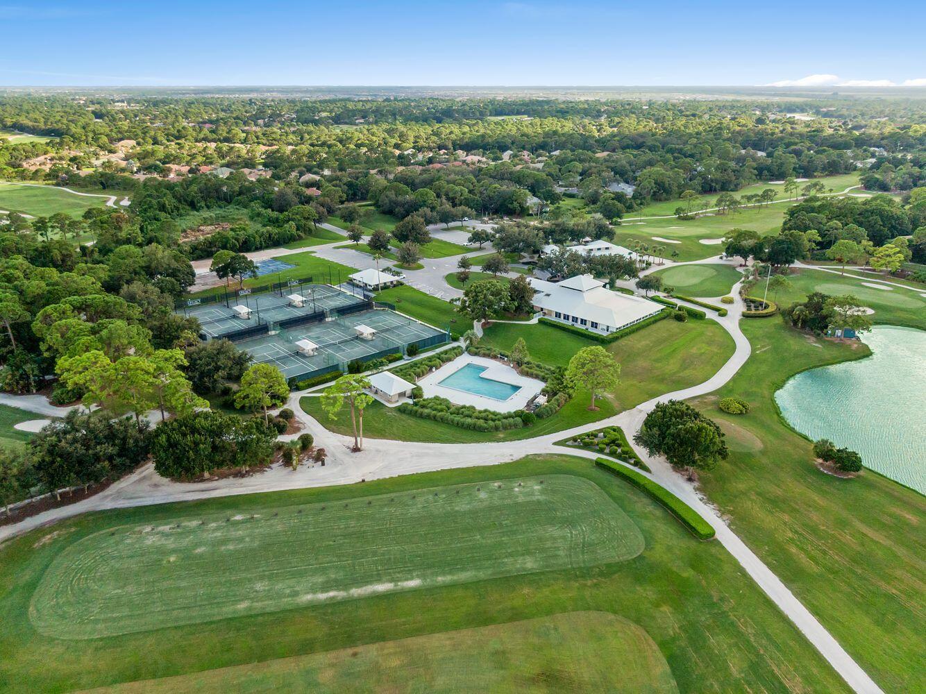 9152 Short Chip Circle Port St. Lucie, FL 34986 - Photo 65 of 72 an aerial view of residential houses with outdoor space and trees