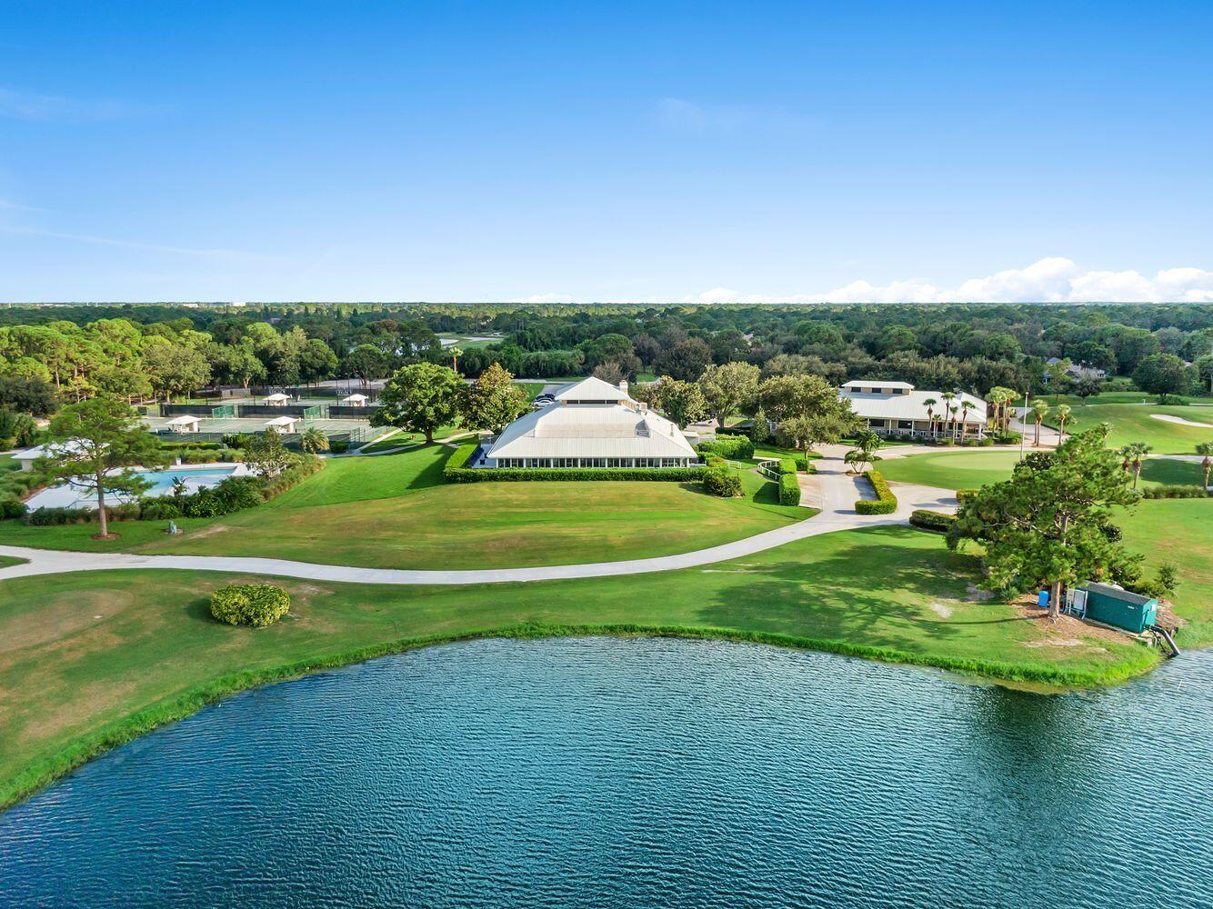 9152 Short Chip Circle Port St. Lucie, FL 34986 - Photo 66 of 72 a view of a golf course with a lake view