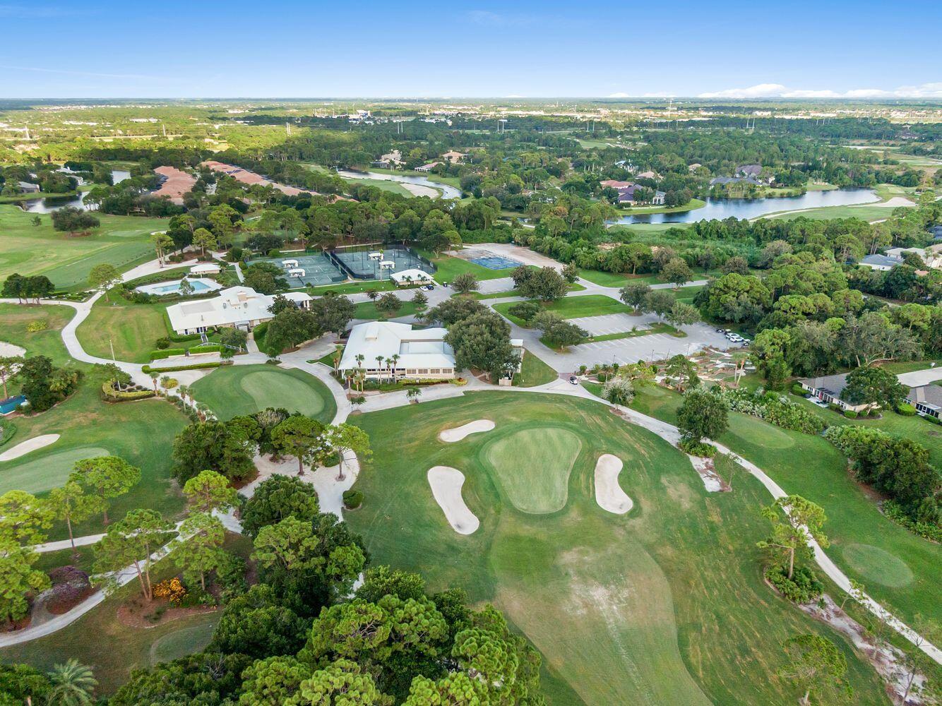 9152 Short Chip Circle Port St. Lucie, FL 34986 - Photo 68 of 72 an aerial view of residential houses with outdoor space and trees