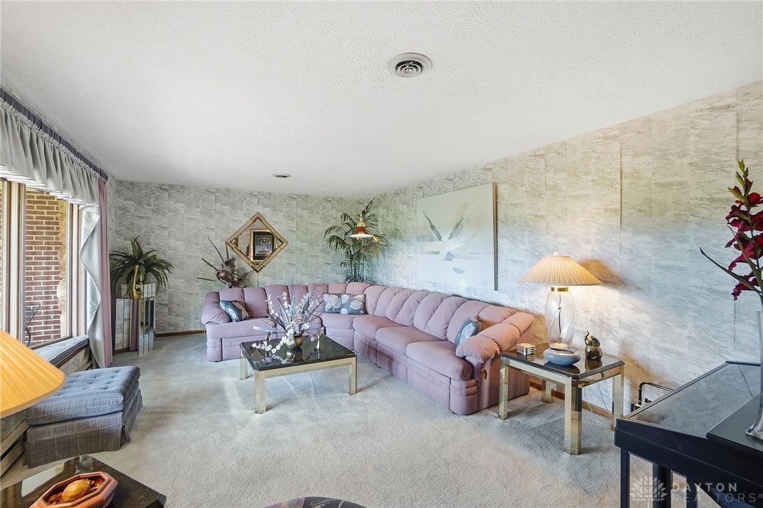 5669 O Neall Road Waynesville, OH 45068 - Photo 18 of 72 This living room offers comfortable carpet flooring, a spacious layout, and ample natural light.