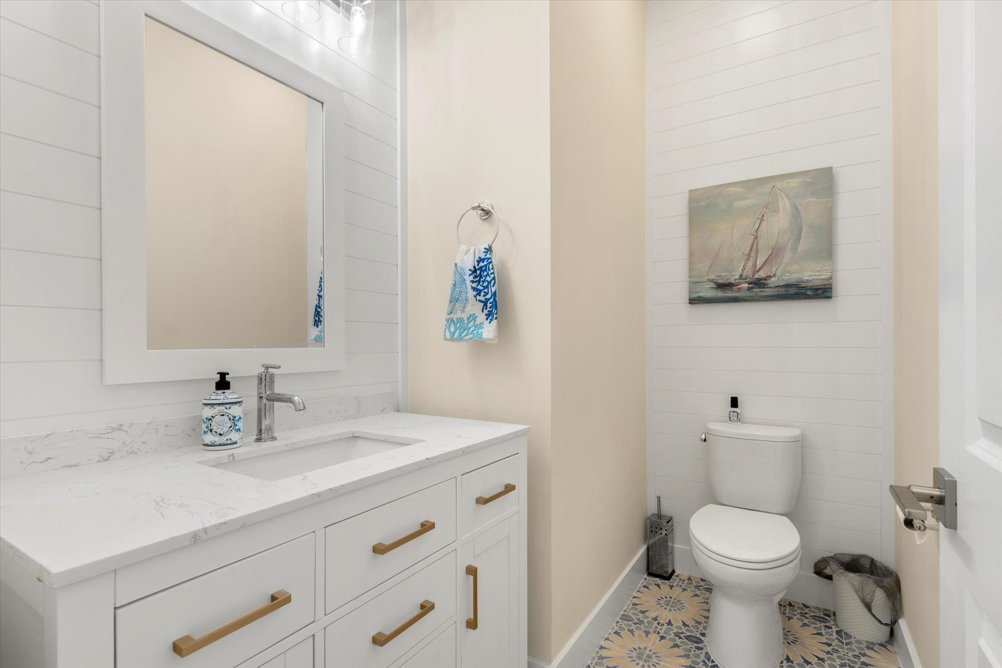 125 5th Street St. Augustine, FL 32080 - Photo 17 of 51 a bathroom with a toilet a sink and mirror