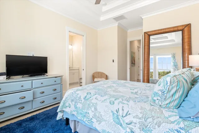 a bedroom with a large bed and flat tv screen on dresser