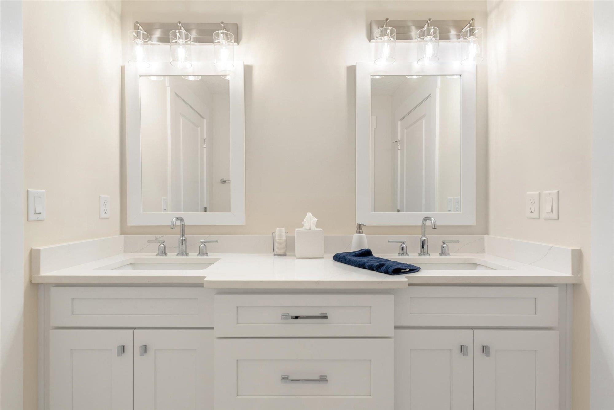 125 5th Street St. Augustine, FL 32080 - Photo 31 of 51 a bathroom with double sink and a mirror
