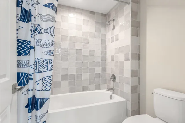 a bathroom with a bathtub and shower