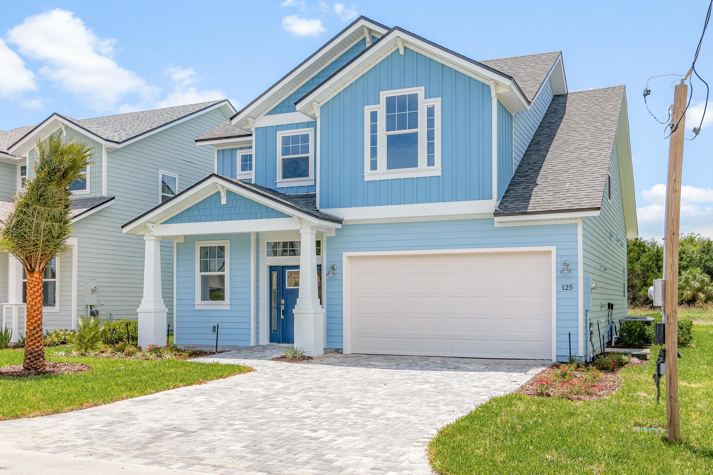 125 5th Street St. Augustine, FL 32080 - Photo 51 of 51 a front view of a house with a yard and garage