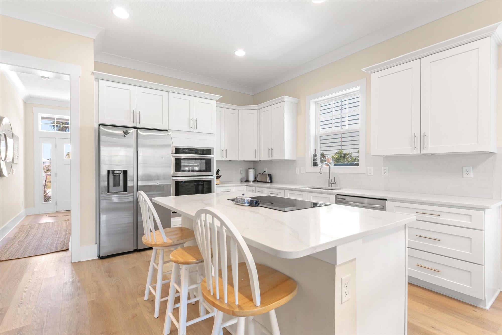 125 5th Street St. Augustine, FL 32080 - Photo 6 of 51 a view of a kitchen with counter top space cabinets and stainless steel appliances