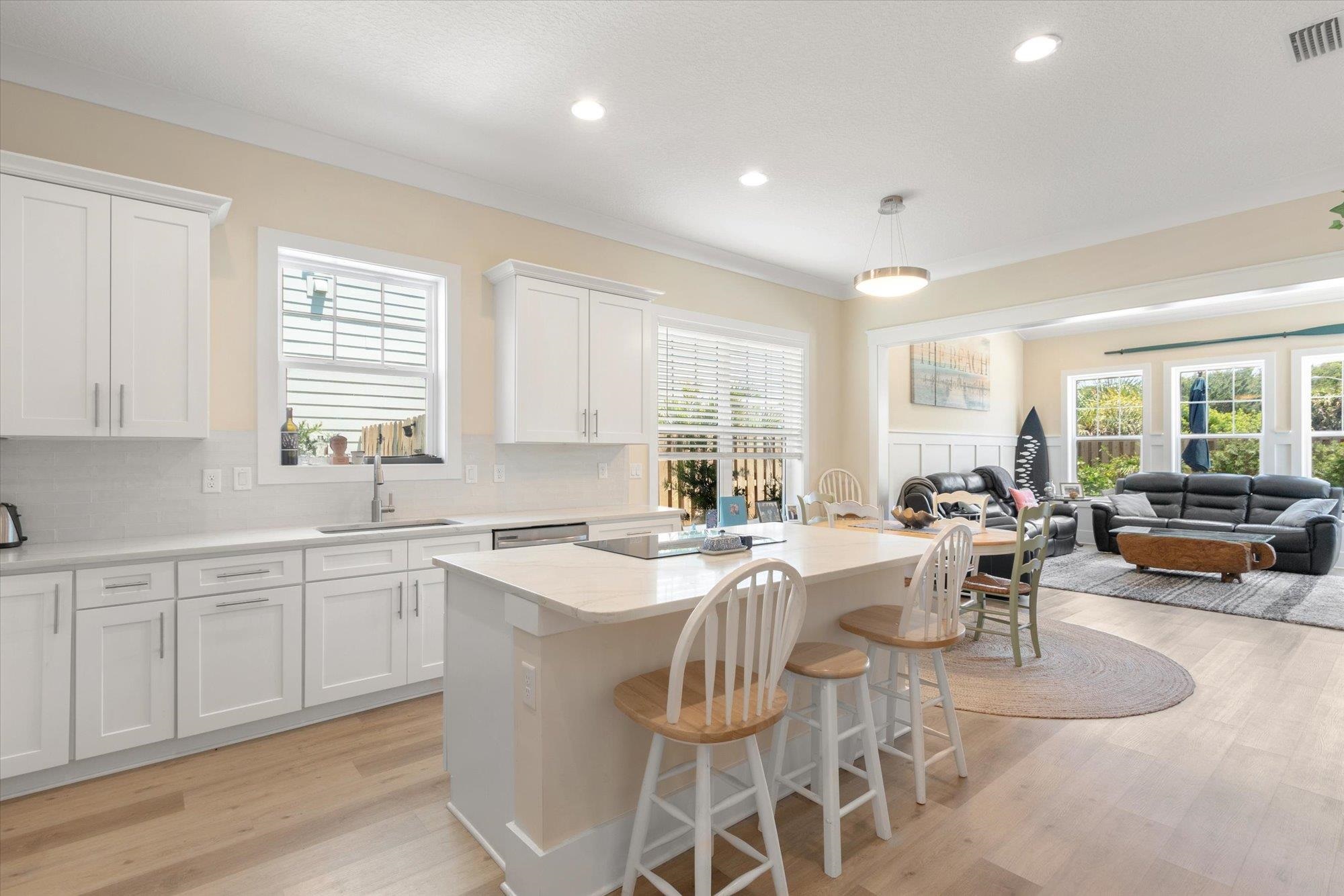 125 5th Street St. Augustine, FL 32080 - Photo 10 of 51 a large kitchen with a large counter top furniture a stove a dining table and chairs
