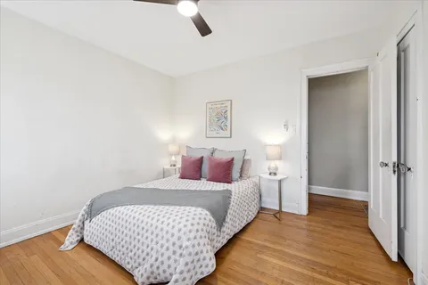 a bedroom with a bed and wooden floor