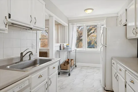 a kitchen with a sink appliances and a window