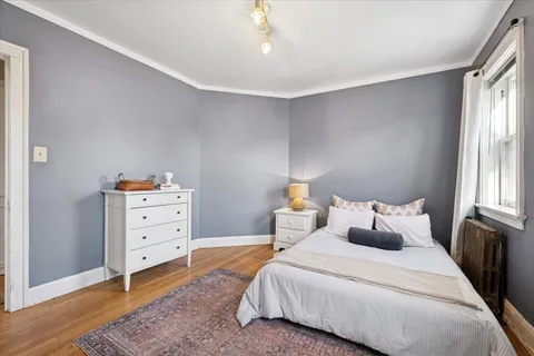 a bedroom with a bed and window