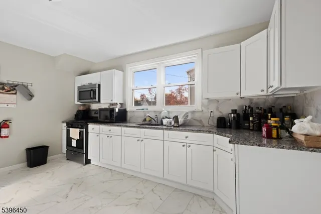 a kitchen with sink and cabinets
