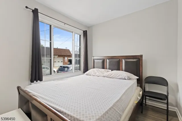 a bedroom with a bed and large window