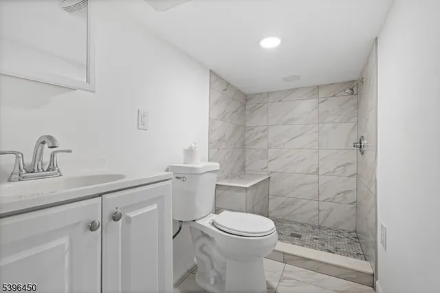 a bathroom with a toilet a sink and shower