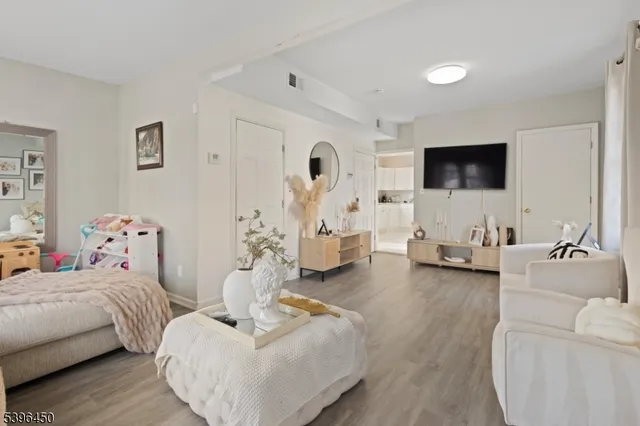 a bedroom with furniture and a flat screen tv