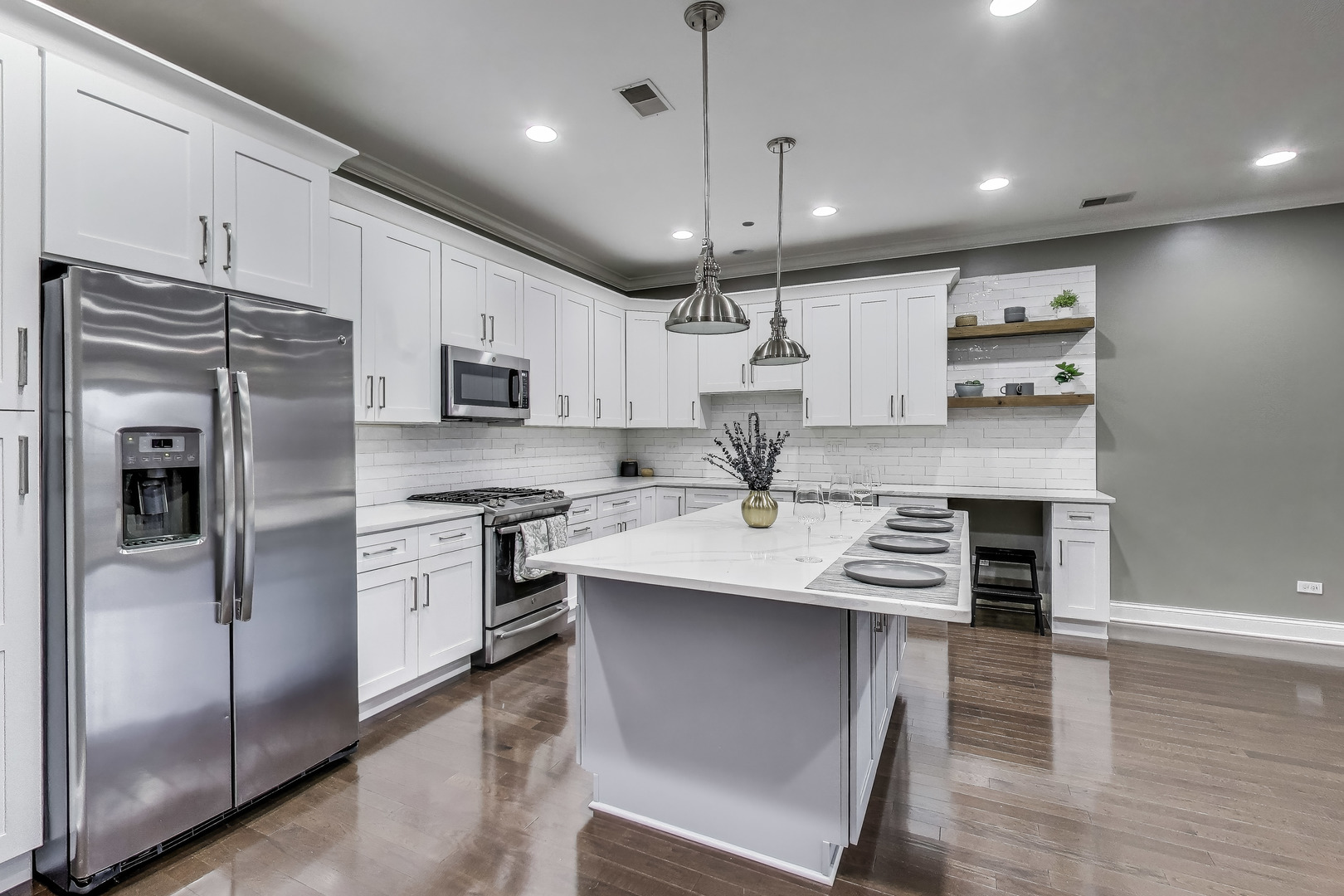 2811 North Bell Avenue, Unit 107 Chicago, IL 60618 - Photo 6 of 37 a kitchen with kitchen island a sink stainless steel appliances and cabinets
