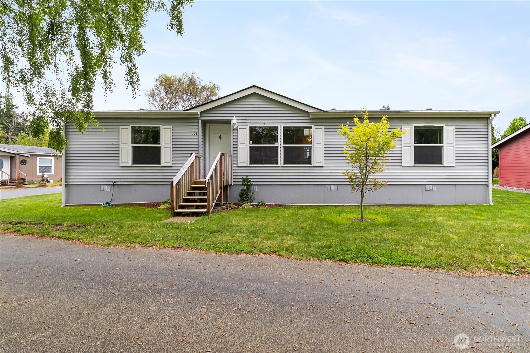a front view of house with yard and green space