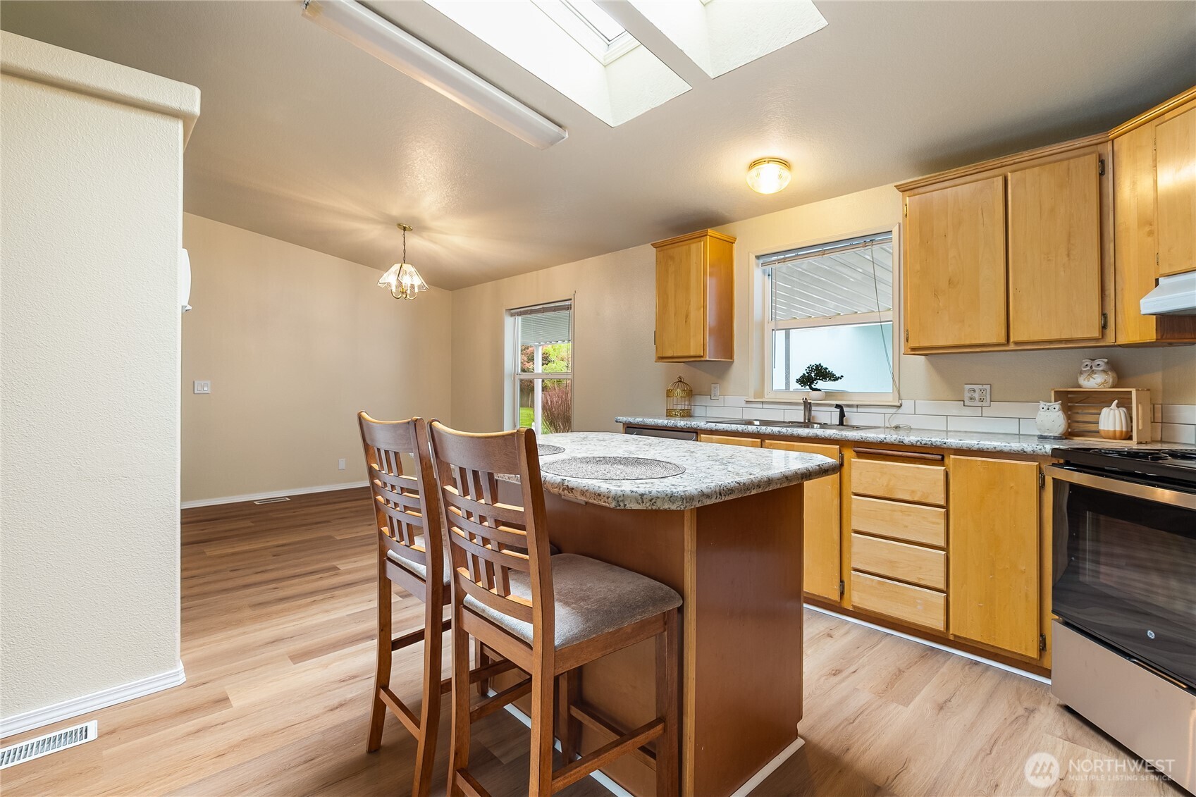 2350 Douglas Road, Unit 30B Ferndale, WA 98248 - Photo 12 of 36 a kitchen with granite countertop a sink a stove a dining table and chairs