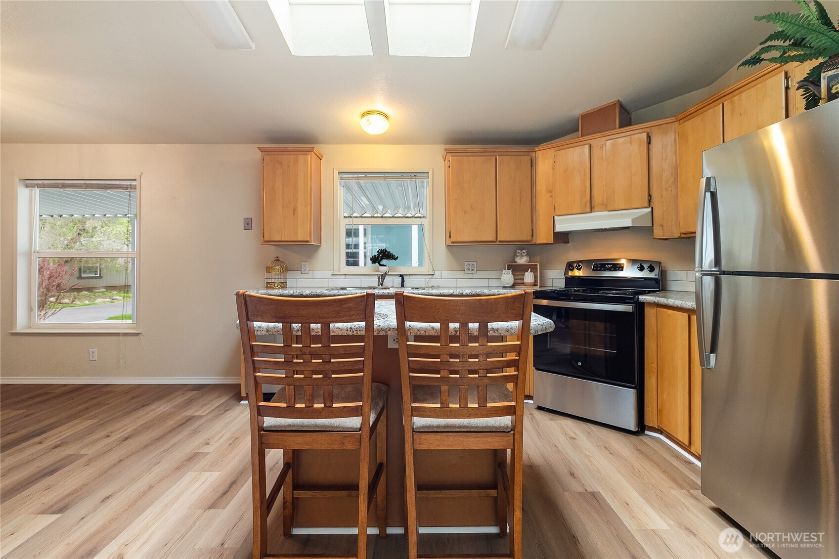 2350 Douglas Road, Unit 30B Ferndale, WA 98248 - Photo 13 of 36 a kitchen with granite countertop a refrigerator stove a sink and dishwasher with wooden floor