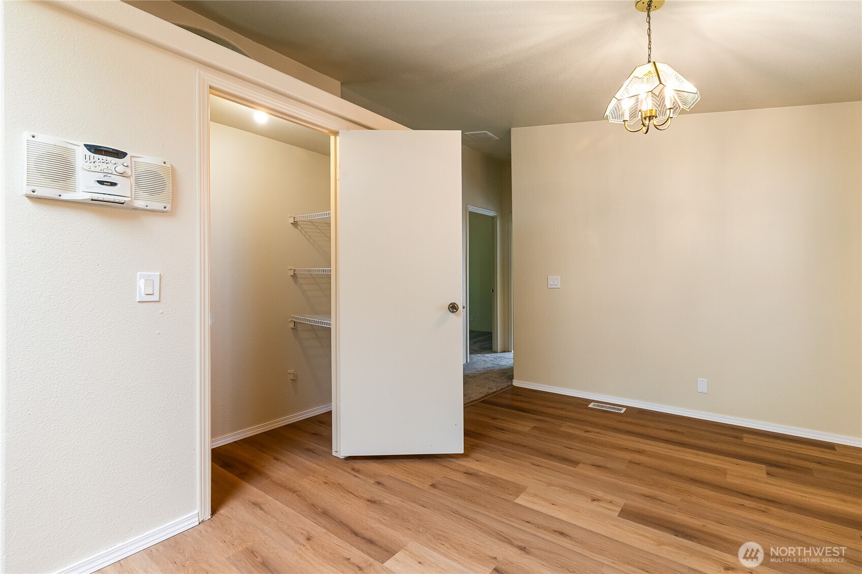 2350 Douglas Road, Unit 30B Ferndale, WA 98248 - Photo 26 of 36 a view of a hallway with wooden floor and a chandelier