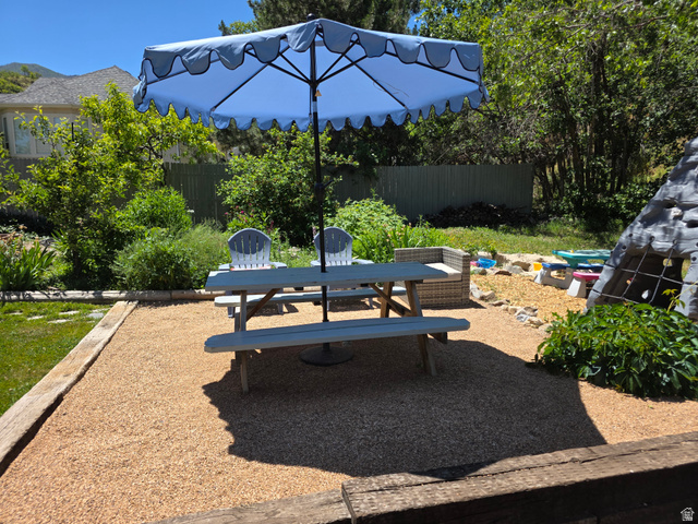 387 North Loafer Canyon Road Payson, UT 84651 - Photo 71 of 94 Gravel patio area with a picnic table and surrounding mature landscaping