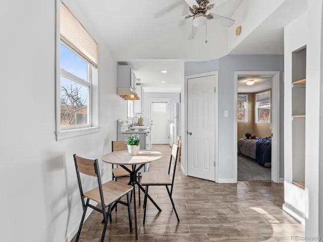 a view of a dining room with furniture and a chandelier