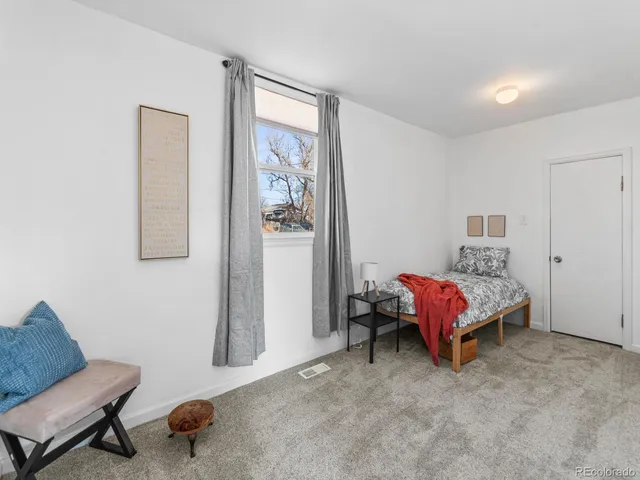 a bedroom with a bed and a couch