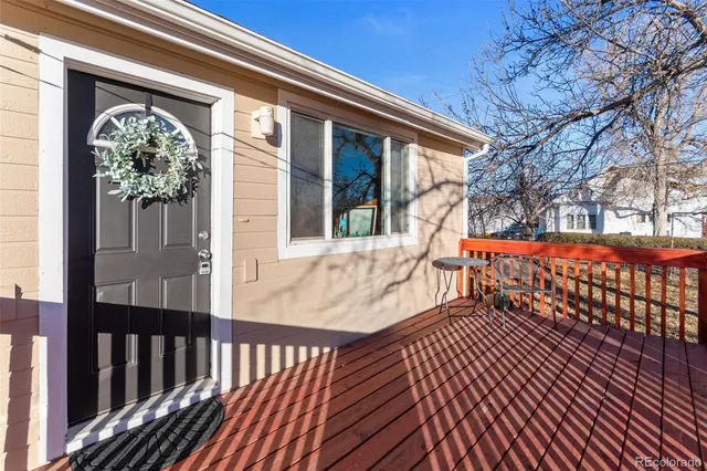 a view of a house with a wooden bench