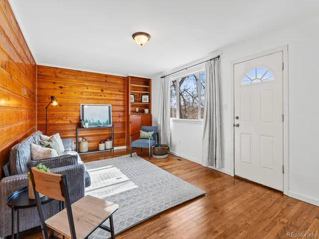 a living room with furniture and a floor to ceiling window