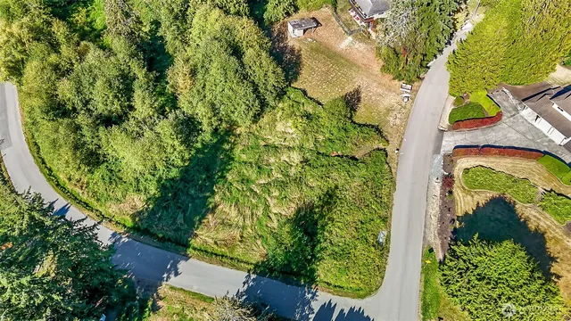an aerial view of a residential houses with yard