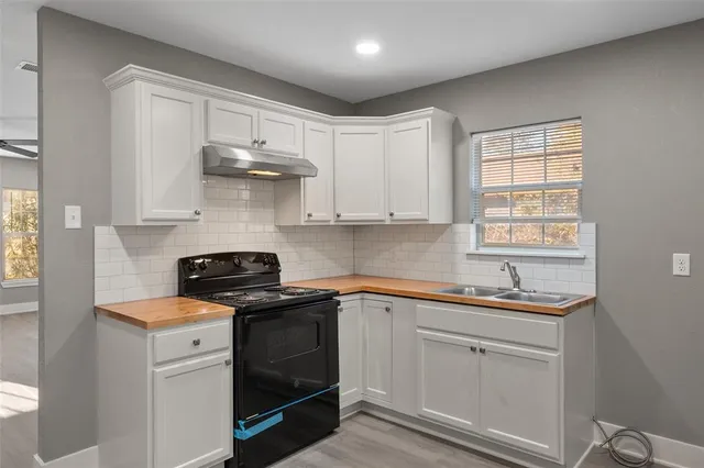 a kitchen with white cabinets and white appliances