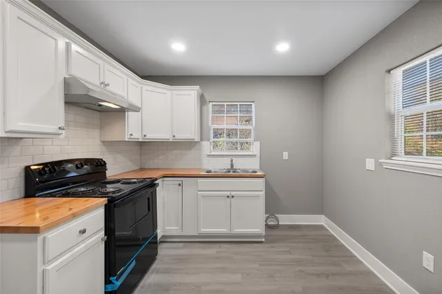 a kitchen with a sink stove and cabinets