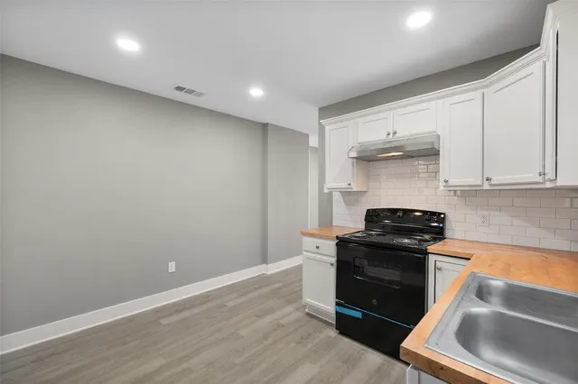 a kitchen with granite countertop a stove and a refrigerator