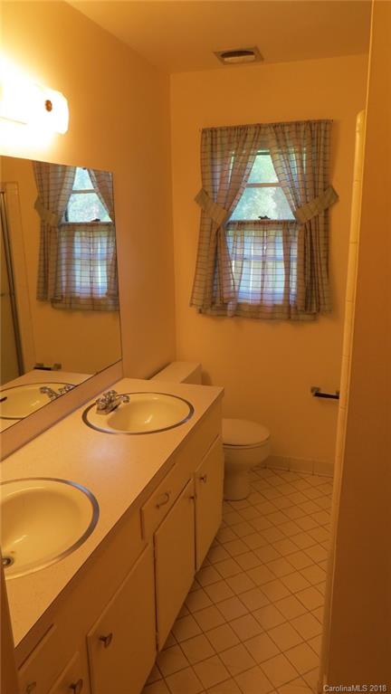 4706 Ridge Road Charlotte, NC 28269 - Photo 14 of 17 a bathroom with a sink toilet and mirror
