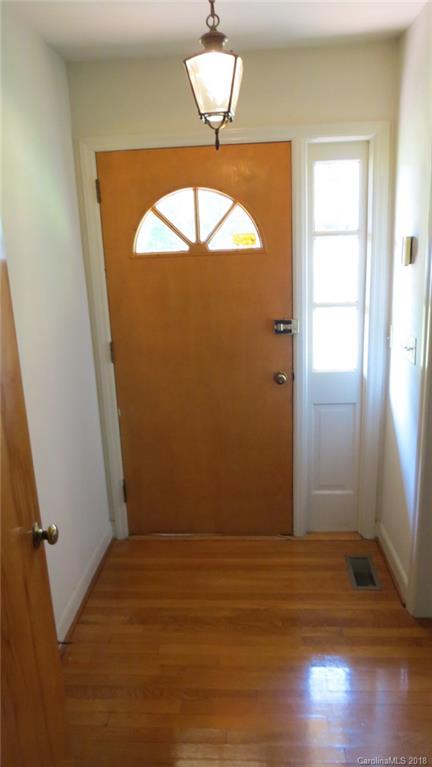 4706 Ridge Road Charlotte, NC 28269 - Photo 7 of 17 an empty room with wooden floor and windows