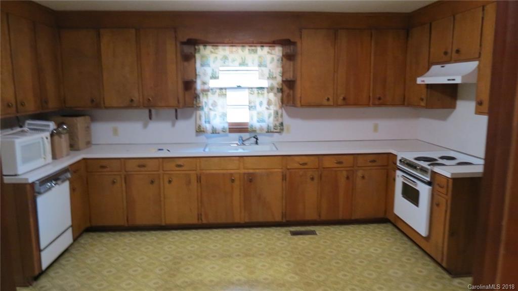 4706 Ridge Road Charlotte, NC 28269 - Photo 10 of 17 a kitchen with wooden cabinets and a stove top oven