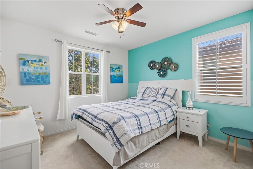 3380 Pine Ridge Loop Ontario, CA 91761 - Photo 24 of 37 a bedroom with a bed and a chandelier