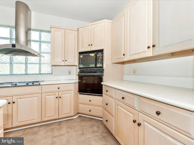 a bathroom with a granite countertop toilet a sink and a shower