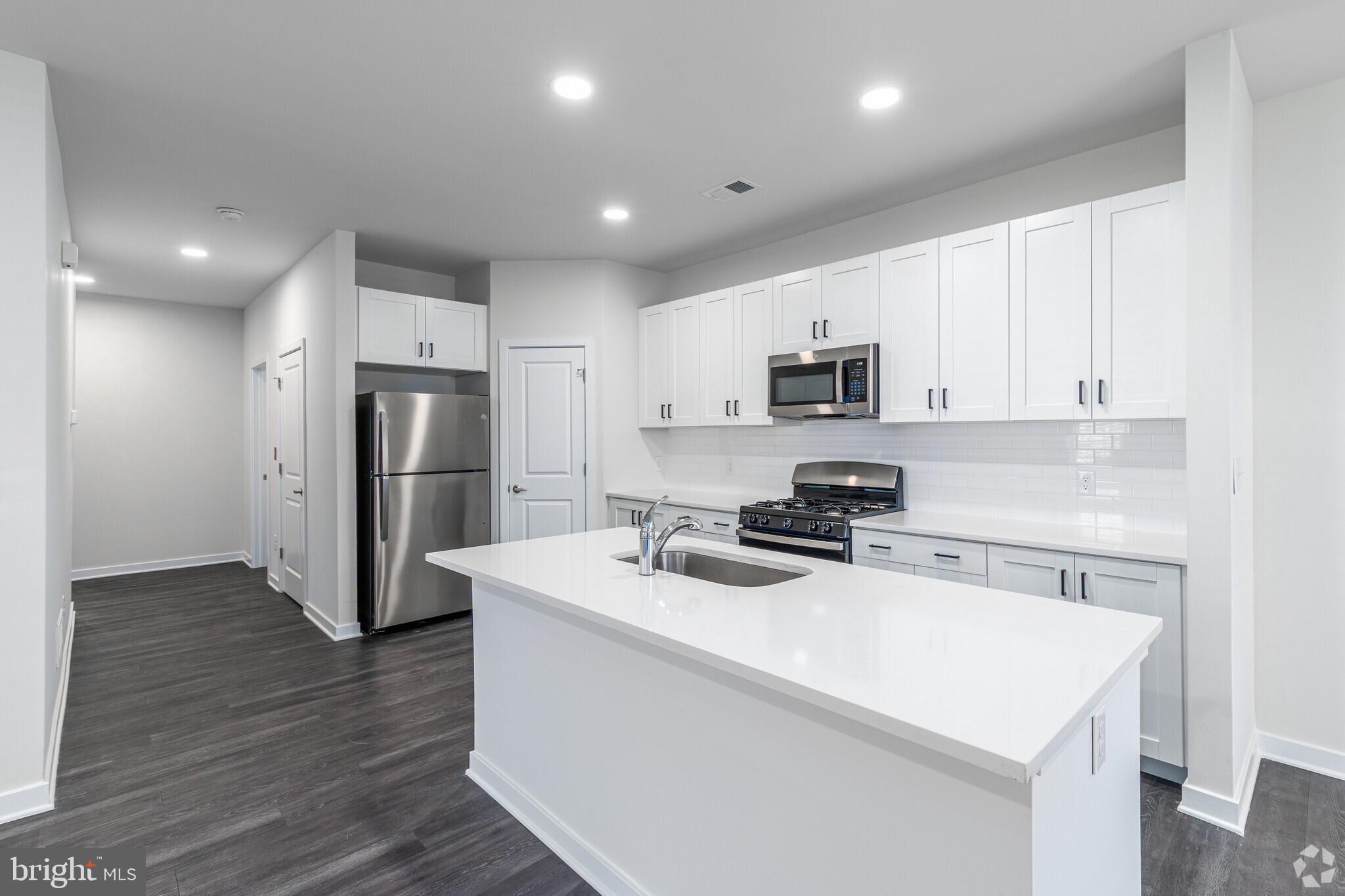 511 Nickerjack Way Dover, DE 19904 - Photo 2 of 7 a kitchen with refrigerator cabinets and wooden floor