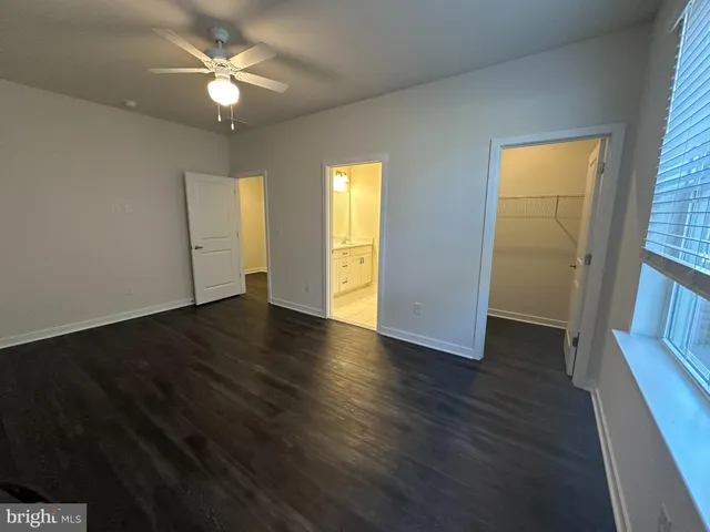 an empty room with wooden floor and window
