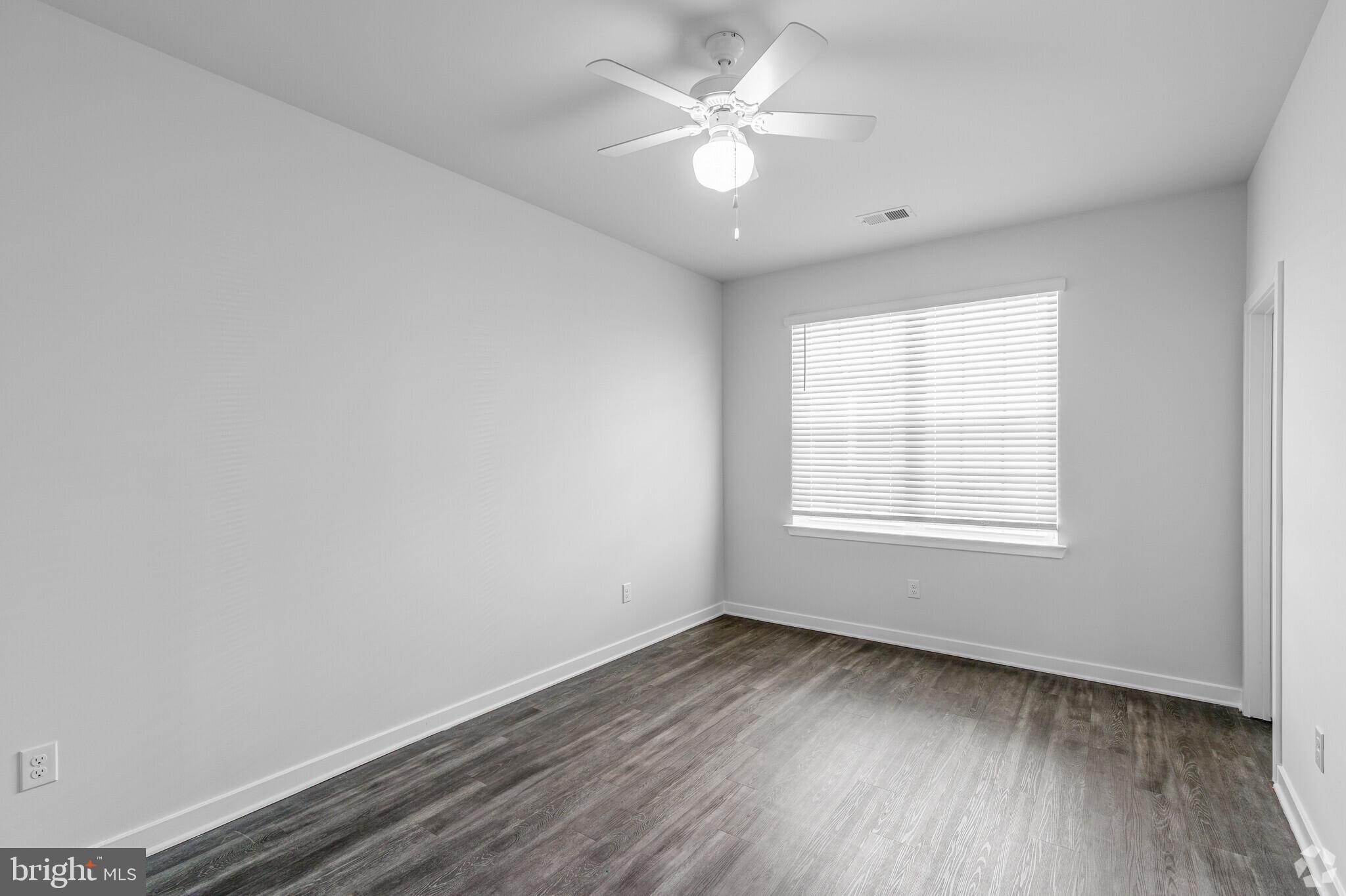 511 Nickerjack Way Dover, DE 19904 - Photo 5 of 7 an empty room with wooden floor and window