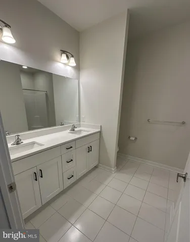 a spacious bathroom with a double vanity sink mirror and