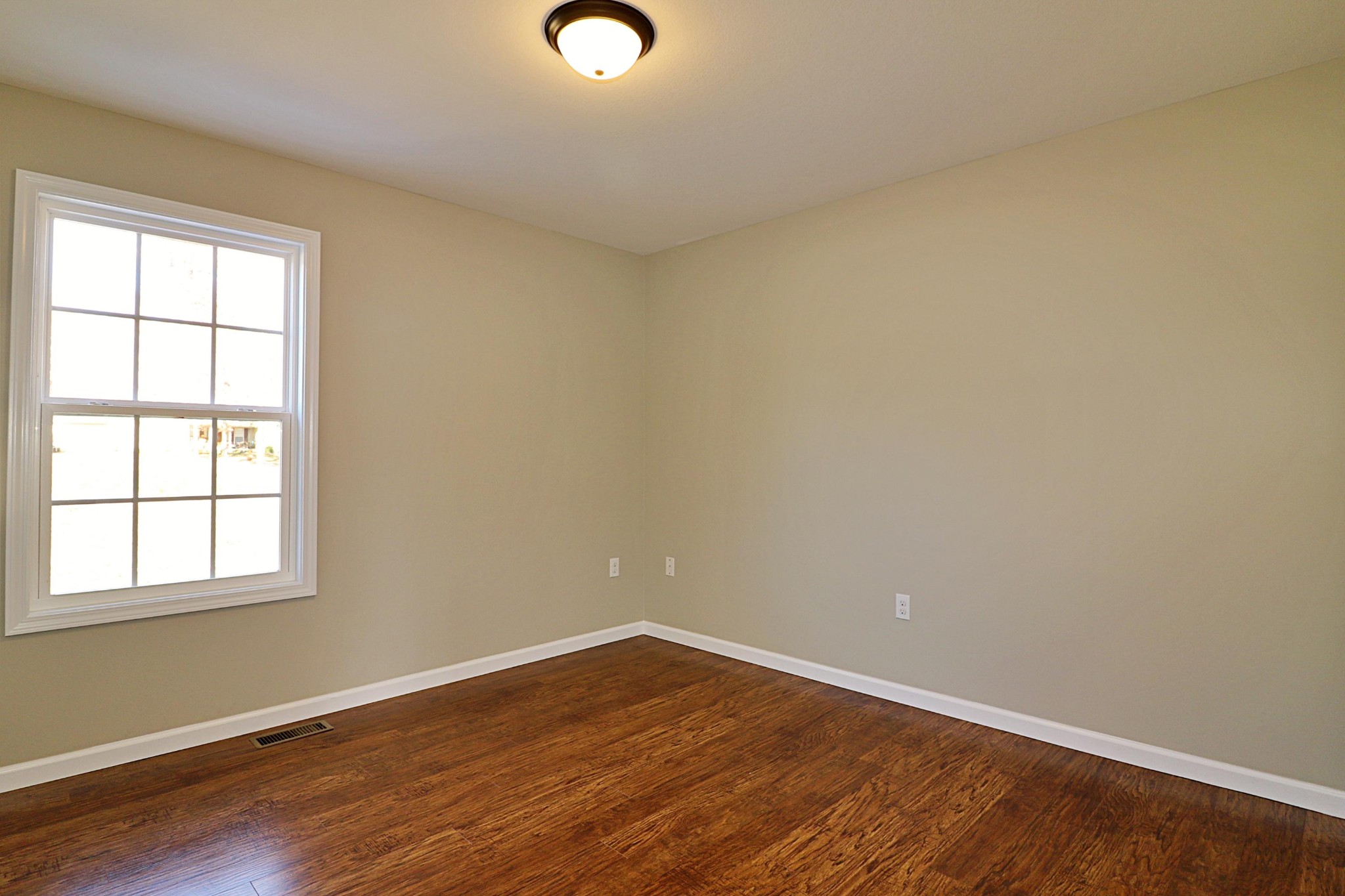 391 Toomey Falls Road Oneida, TN 37841 - Photo 23 of 42 an empty room with wooden floor and windows